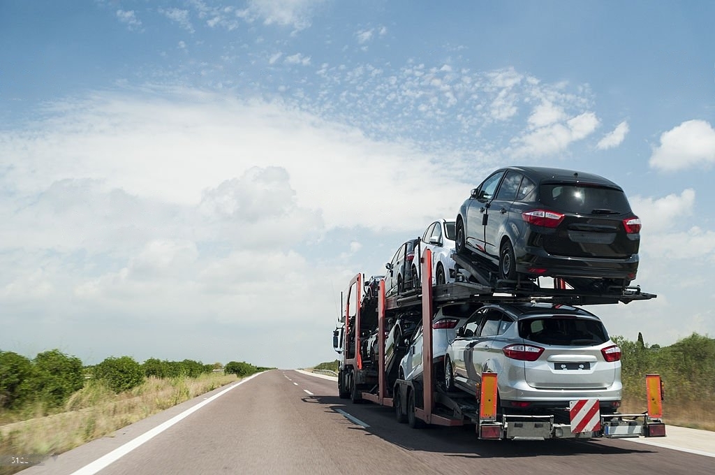 Many car loads on car hauler travel to another state